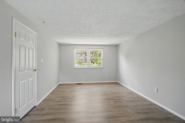 5694 Singletree Dr, Frederick, MD 21703 - empty room with a textured ceiling, wood finished floors, and baseboards