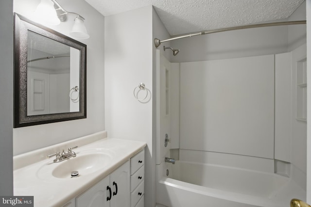 5694 Singletree Dr, Frederick, MD 21703 - bathroom featuring a textured ceiling, shower / bathtub combination, and vanity