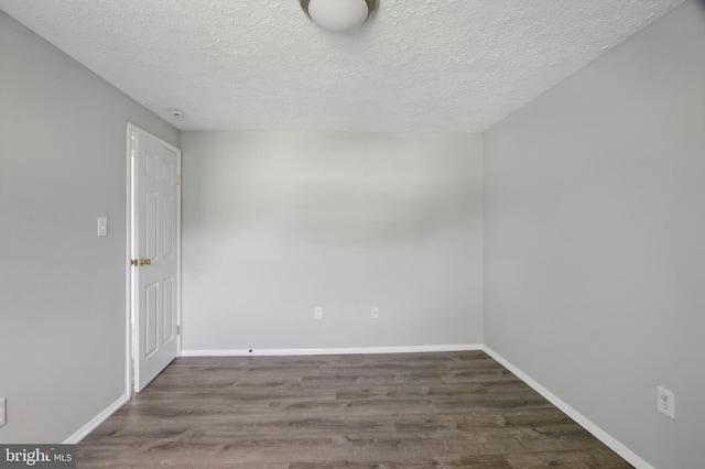 5694 Singletree Dr, Frederick, MD 21703 - empty room featuring wood finished floors, a textured ceiling, and baseboards