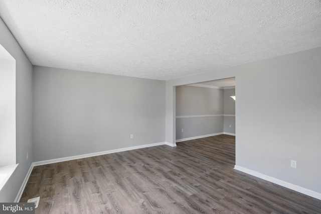 5694 Singletree Dr, Frederick, MD 21703 - empty room featuring dark wood finished floors, a textured ceiling, and baseboards