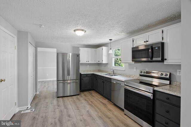 5694 Singletree Dr, Frederick, MD 21703 - kitchen with appliances with stainless steel finishes, a sink, light wood-type flooring, white cabinetry, and gray cabinets