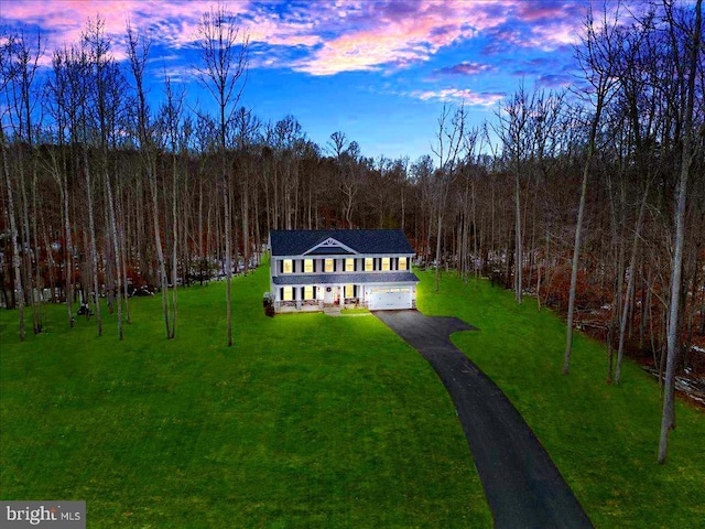 aerial view at dusk with a wooded view