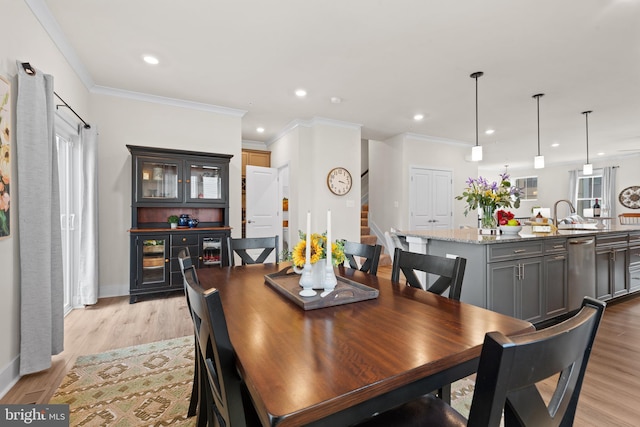 dining room featuring recessed lighting, light wood-type flooring, and stairs
