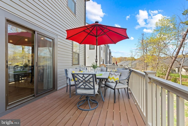 wooden terrace with outdoor dining space