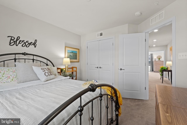 bedroom with a closet, carpet floors, and visible vents