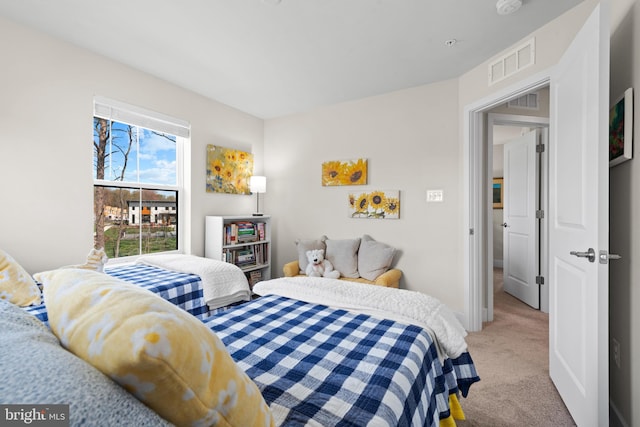 bedroom featuring baseboards, visible vents, and carpet