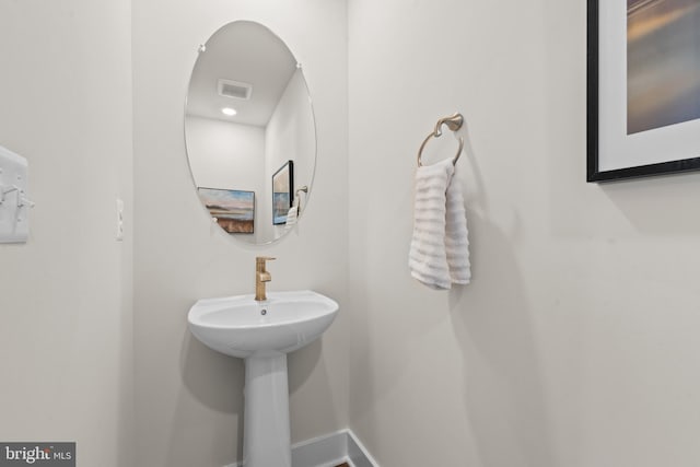 bathroom featuring baseboards and visible vents