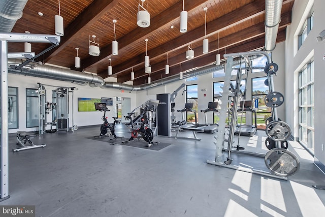 workout area with a towering ceiling and wood ceiling