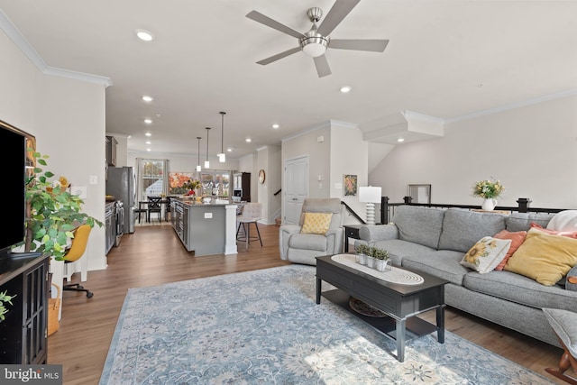 living area featuring recessed lighting, light wood-style floors, ceiling fan, and ornamental molding