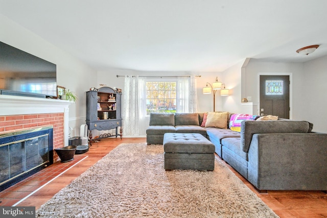 living area featuring a fireplace and wood finished floors