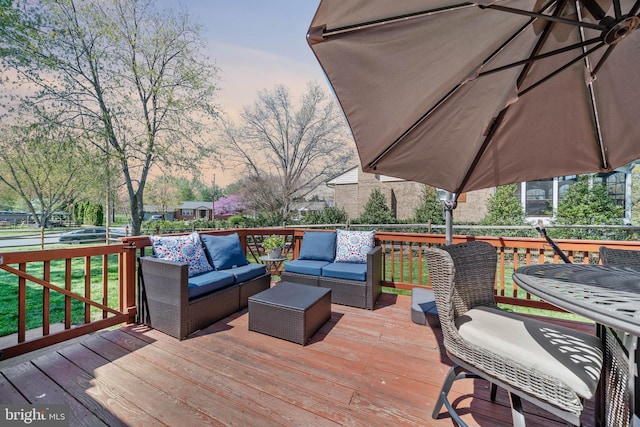 deck at dusk featuring an outdoor living space