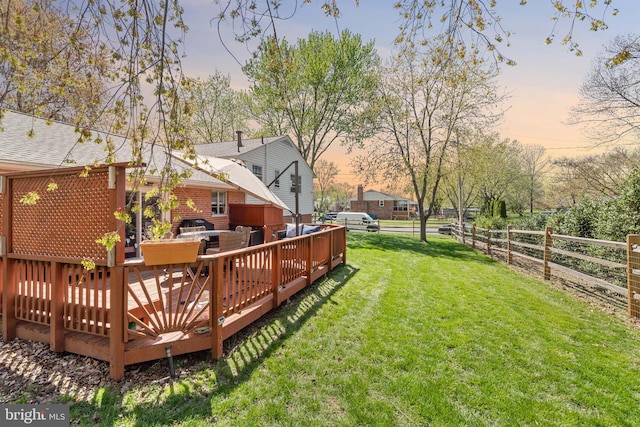 view of yard with fence and a deck