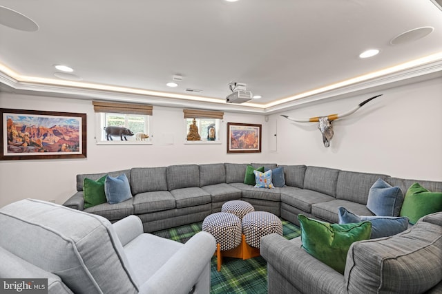 living room with a tray ceiling and recessed lighting