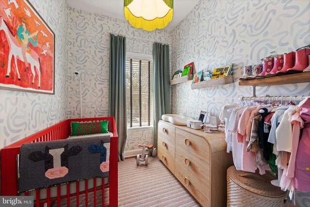 bedroom with wallpapered walls and carpet