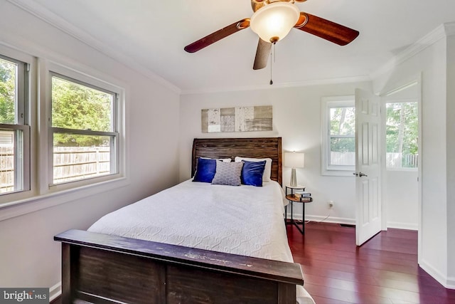 bedroom with crown molding, hardwood / wood-style floors, baseboards, and a ceiling fan