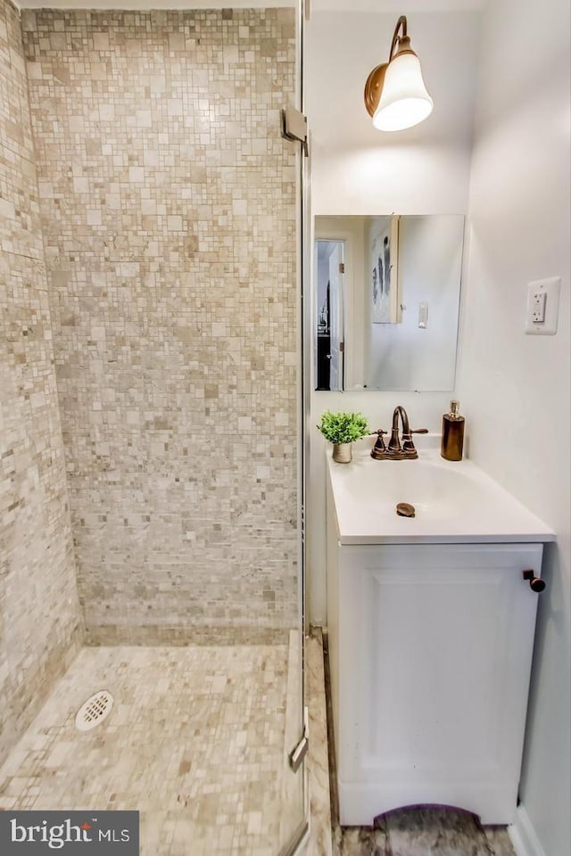 full bathroom featuring a stall shower and vanity