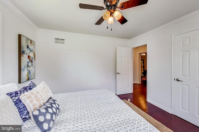 bedroom featuring crown molding, ceiling fan, dark wood-style floors, and visible vents