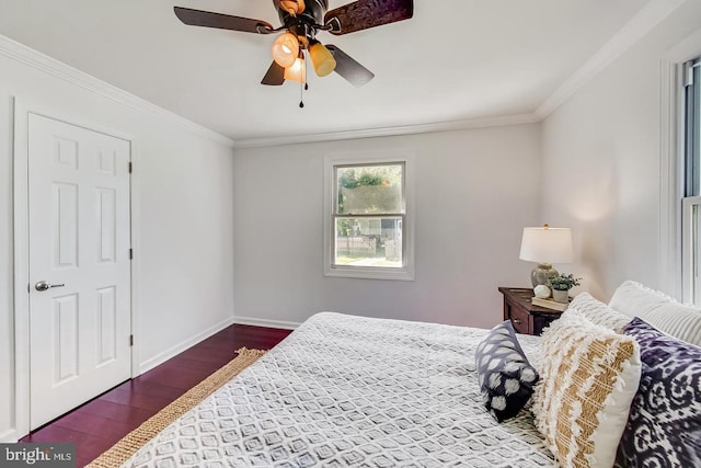 bedroom with wood finished floors, ceiling fan, baseboards, and ornamental molding