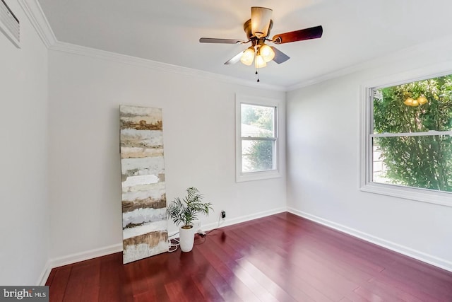spare room with ornamental molding, baseboards, a ceiling fan, and wood finished floors