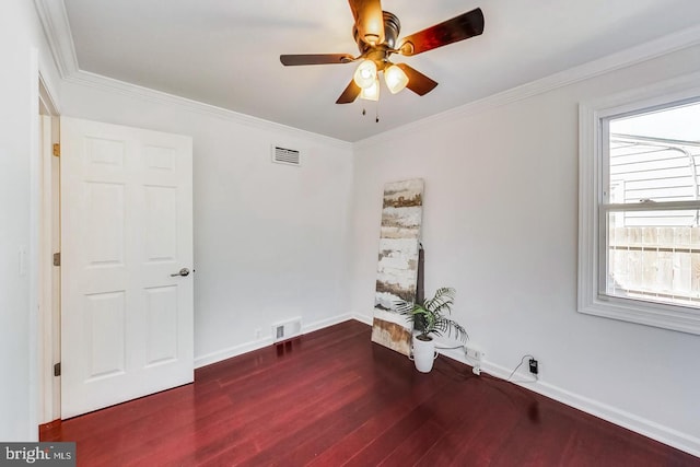 unfurnished room featuring wood finished floors, ceiling fan, baseboards, and visible vents