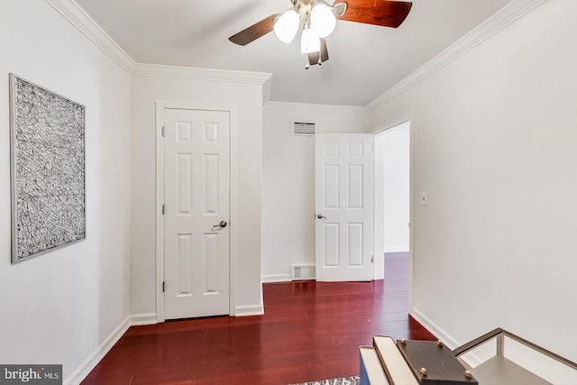 unfurnished bedroom with wood finished floors, baseboards, ornamental molding, and visible vents