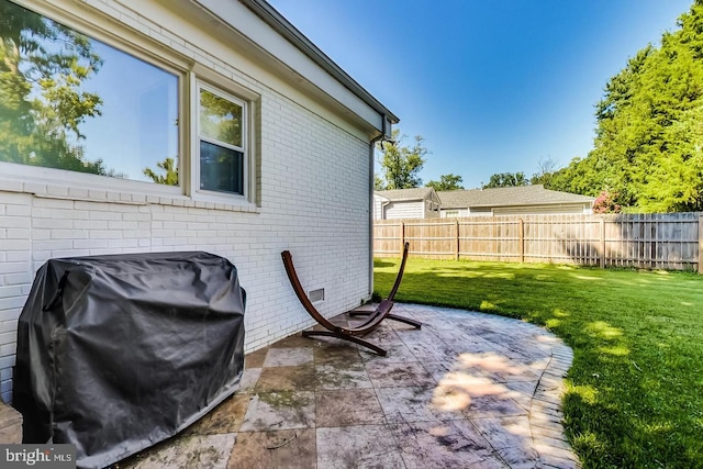 view of patio featuring a fenced backyard and a grill
