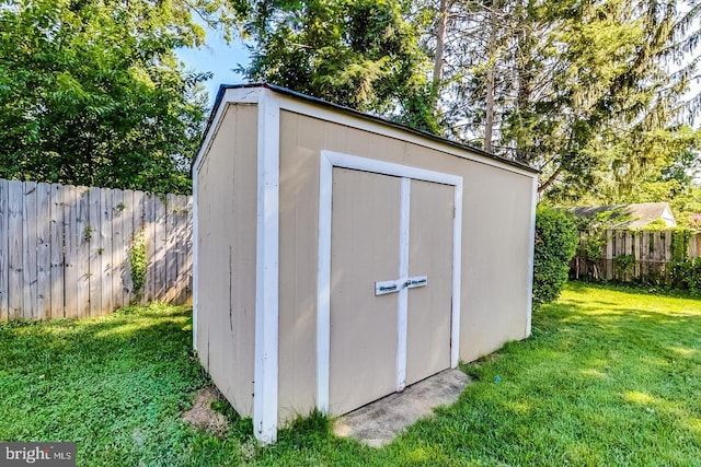 view of shed with a fenced backyard