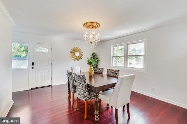 dining area featuring crown molding, a notable chandelier, dark wood-style floors, and plenty of natural light