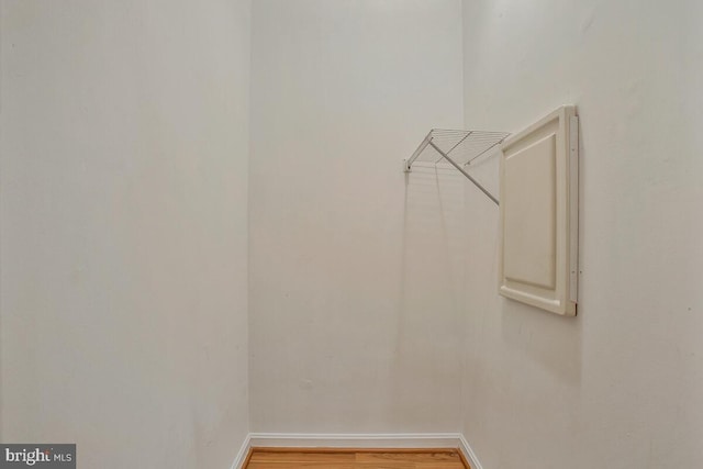 walk in closet featuring wood finished floors