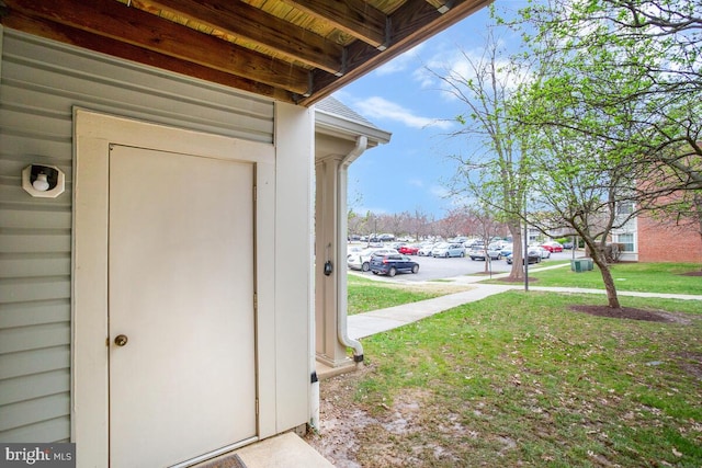 doorway to property with a yard