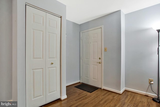 entrance foyer with baseboards and wood finished floors