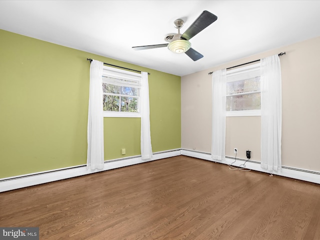 spare room with ceiling fan and dark wood finished floors