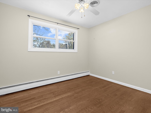 spare room with baseboard heating, baseboards, visible vents, ceiling fan, and wood finished floors