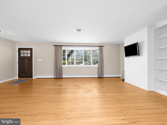 unfurnished living room with visible vents, built in shelves, light wood finished floors, and baseboards
