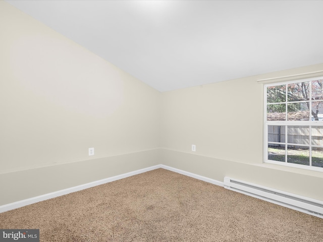 empty room featuring baseboards, carpet flooring, a baseboard heating unit, and vaulted ceiling