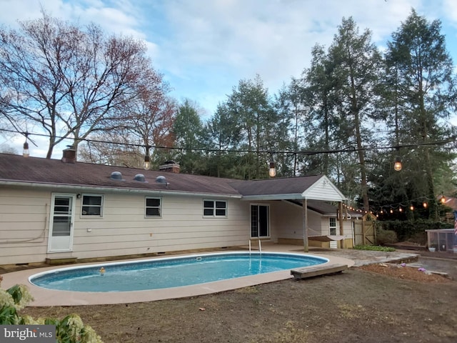 pool featuring a patio and fence