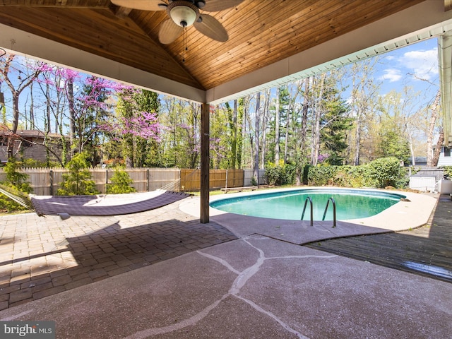 view of swimming pool featuring a fenced backyard, ceiling fan, a fenced in pool, and a patio