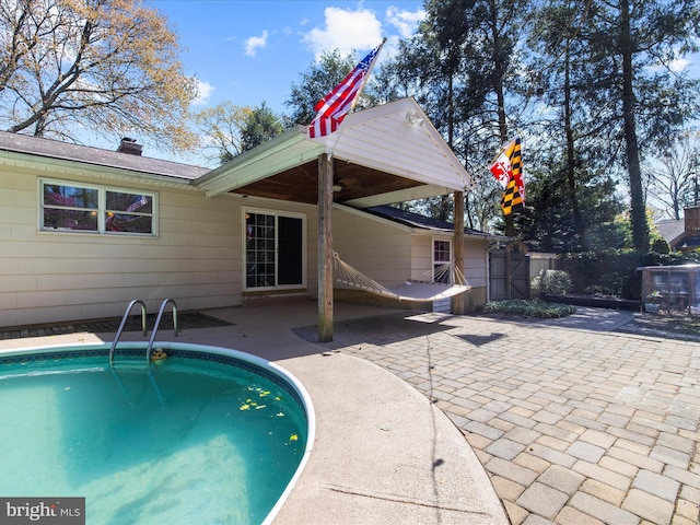 back of property with a patio, a chimney, and fence