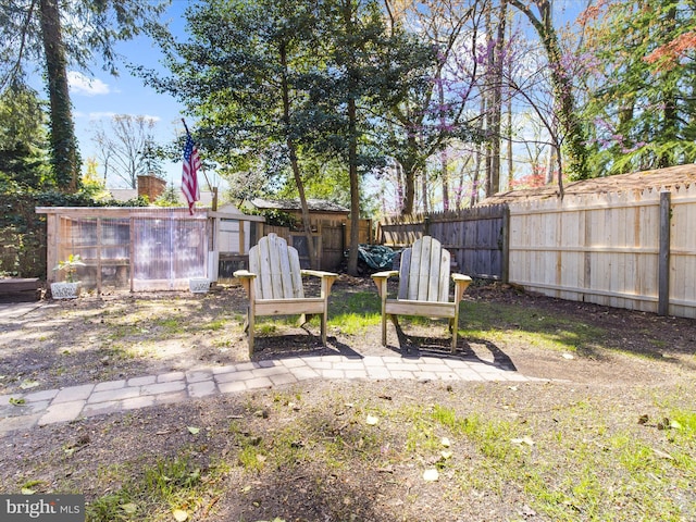 view of yard featuring a fenced backyard and an outdoor structure