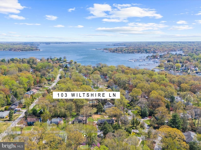 aerial view with a forest view and a water view