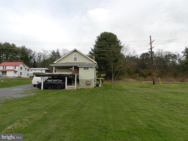 exterior space featuring a lawn and driveway