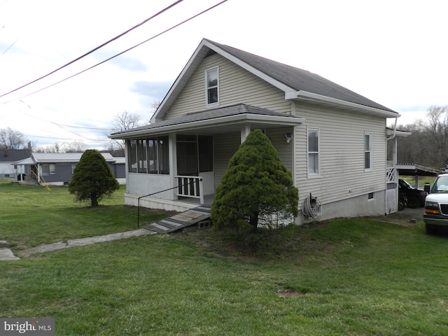 view of front of house featuring a sunroom and a front lawn