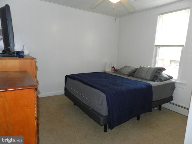 bedroom with a baseboard radiator, carpet floors, baseboards, and ceiling fan