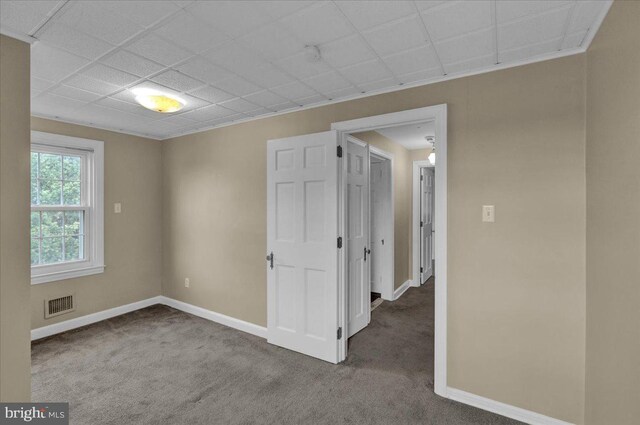 interior space featuring visible vents, baseboards, and carpet floors