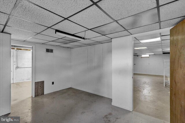 finished below grade area with visible vents and a drop ceiling