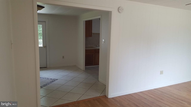 spare room featuring light wood finished floors and baseboards
