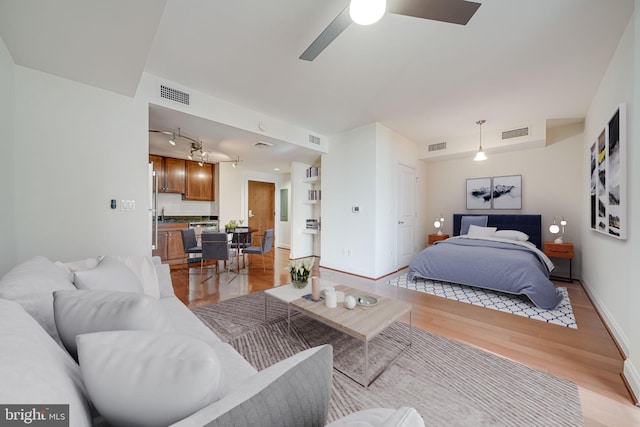 bedroom featuring visible vents, baseboards, and light wood-type flooring