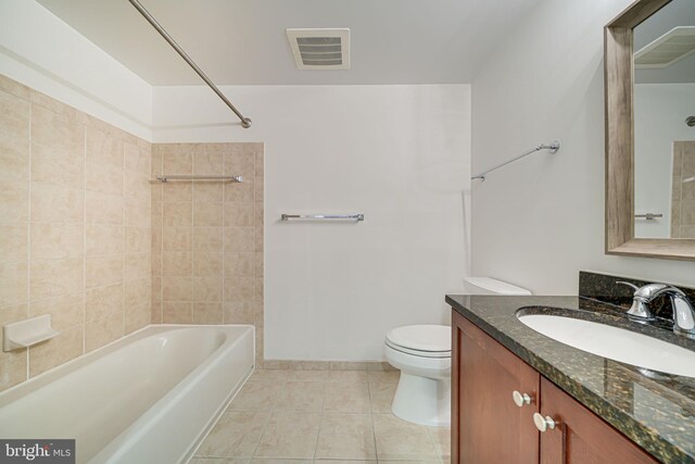 bathroom featuring tile patterned floors, toilet, vanity, visible vents, and tub / shower combination