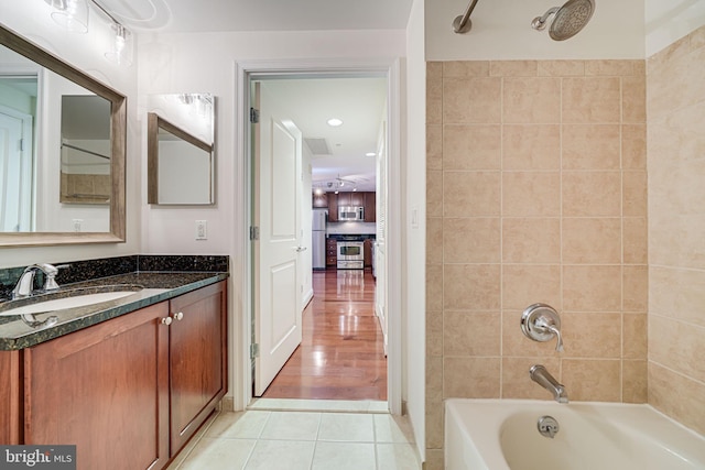 bathroom with tile patterned flooring, tub / shower combination, and vanity