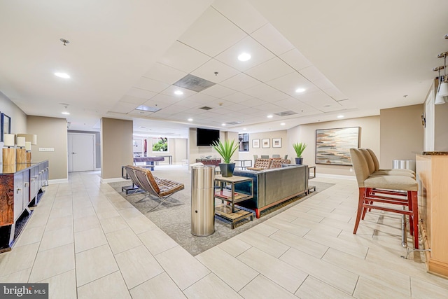 living area with recessed lighting, light tile patterned flooring, visible vents, and baseboards
